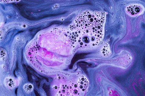 Indulgent spa experience with a purple bath bomb fizzing in a .